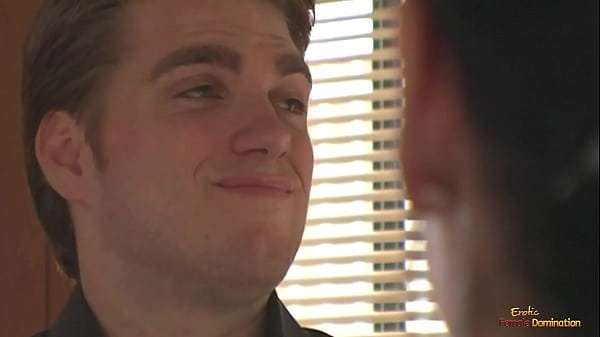 A busty brunette ties a man to the cross and makes him lick her pussy.