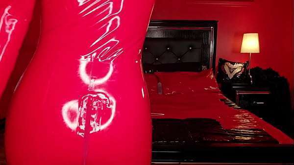 Hot MILF in red latex catsuit spreading ass